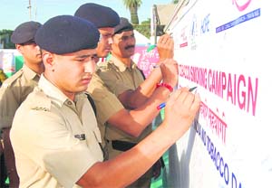 Policemen sign a pledge against smoking in Dehradun on Sunday. 