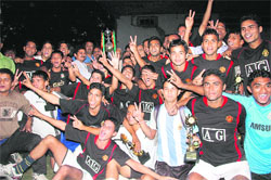 The Uttarakhand Police football team poses with the Dehradun Football League Trophy in Dehradun on Sunday.