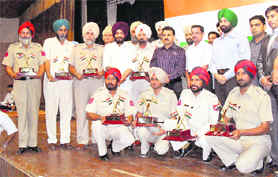 Police personnel strike a pose after being honoured in Ludhiana on Sunday. 