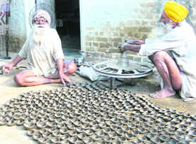 Swaran Singh works at potters wheel in his home at Jalaldiwal village near Raikot.