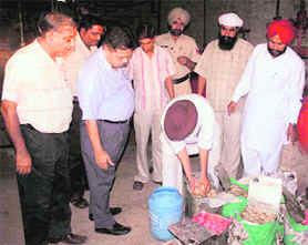 Ferozepur civil surgeon Dalip Kumar supervises sampling of sweets in Fazilka.