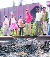Villagers watch a railway track blown up by Maoists during the 48-hour bandh in protest against the arrest of top Naxal leaders by the police on Monday.