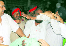 Man being thrashed by residents at a level-crossing near Aman chicken in Ludhiana on Sunday.