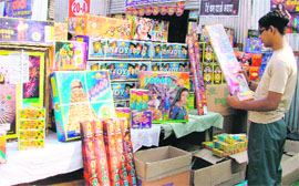 Buyers look at the latest Indian and Chinese crackers at Dana Mandi in Ludhiana on Monday.
