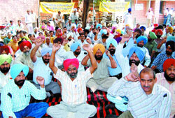 Agriculture Department employees demonstrate outside the DC office in Amritsar on Tuesday.