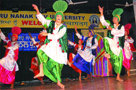 Students perform Bhangra during the youth festival in Guru Nanak dev University in Amritsar on Tuesday.