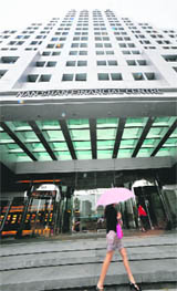 A woman walks past the Nan Shan Life Insurance building in Taipei on Tuesday.