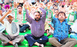 Employees of the electricity department stage a dharna in front of their office in Sector 18 in Chandigarh