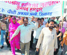 Residents of Jwalapur take out a march in the town on Tuesday.