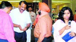 Umesh Aggarwal, a BJP leader, argues with medical officials conducting a raid at a sweets shops in Dehradun on Tuesday.