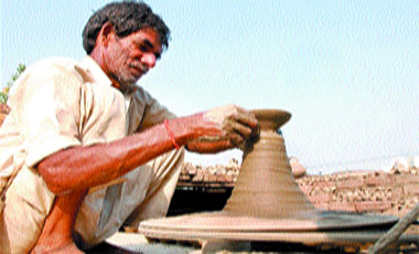 The lightman at his job: A potter readies diyas for Divali in Jalandhar.