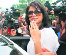 Bollywood actor Priyanka Chopra shows the ink mark on her finger as she leaves after casting her vote at Versova in Mumbai on Tuesday.