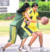 A match in progress during the Panjab University Inter-College Basketball (women) Championship in Chandigarh on Wednesday.