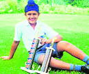Ten-year-old Karandeep Kochhar relaxes on the greens of the Chandigarh Golf Club with his trophies on Wednesday. 