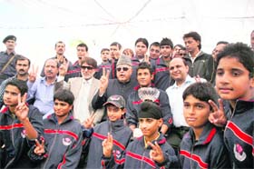 Farooq Abdullah, Union Minster for New and Renewable Energy, poses for a photo with states under-16 cricket team that won the Polly Umrigar Trophy (North Zone) recently, in Jammu