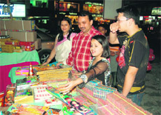 A girl buys crackers at a shop in Dehradun on Thursday. 