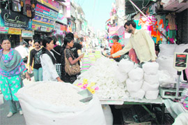 A woman buys sweets on Dhanteras in Dehradun on Thursday