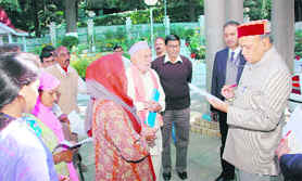 Chief Minister Prem Kumar Dhumal listening to public grievances at Shimla on Thursday.