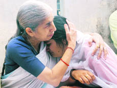 Punjabs Health Minister Laxmi Kanta Chawla consoles Anchal Sharma, widow of Rajnish Sharma, at latters house in Jammu on Thursday. 