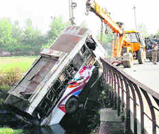 The mangled remains of the ill-fated bus being pulled out of the drain near Bhakana Kalan village on Thursday.