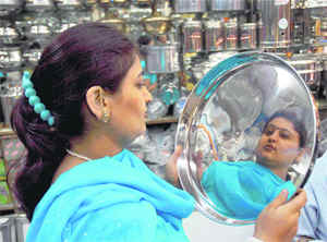 A woman purchases utensils on the occasion of Dhanteras in Amritsar on Thursday. 