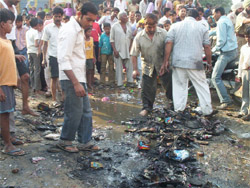 Shopkeepers extinguishing the fire after a stall selling crackers caught fire and was reduced to ashes in Fazilka.