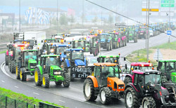 French farmers drive with their tractors to the Flaubert bridge in Rouen during a nationwide day of protest against their deteriorating economic conditions due to a fall in agricultural prices, on Friday. 