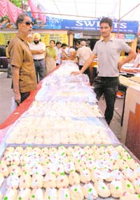 People buy sweets from a stall in Chandigarh