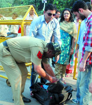 Delhi police personnel check the bag of a shopper at Sarojini Nagar Market in New Delhi on Friday.
