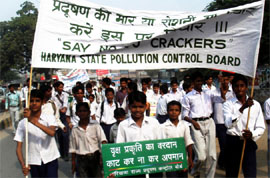 Schoolchildren carry banners with messages of celebrating a cracker-free Divali in Gurgaon on Friday.