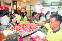 Buyers at a sweets shop on the eve of Diwali in Dehradun on Friday. 