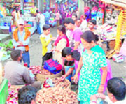 People buy earthen lamps on the eve of Diwali at Dharamsala on Friday.