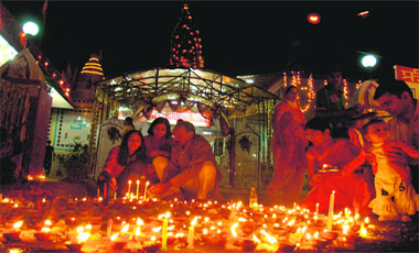 Devotees light candles on the occasion of Diwali in Chandigarh on Saturday.