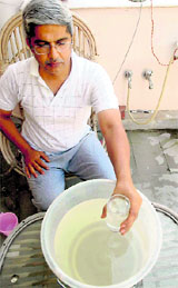 A resident of Sector 21, Chandigarh, shows muddy water on Sunday.