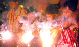 Children burn crackers at Divali on Saturday.