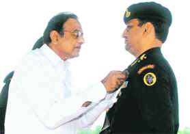 Union Home Minister P Chidambaram presents President Police Medal to Commandant Satish Budakoti at Manaser in Gurgaon.