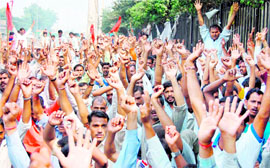 At least 3,000 RECO workers protest in front of the office of their company in Gurgaon on Sunday.