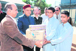 Chief Minister PK Dhumal distributes sweets and crackers to children of Bal Ashram at Tutikandi on Diwali in Shimla