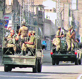 Pakistani troops patrol a street in Bannu, Waziristan.