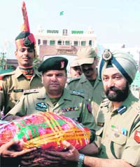 BSF Commandant MS Dhillon offers sweets to Pakistani Rangers on Diwali at Wagah Border