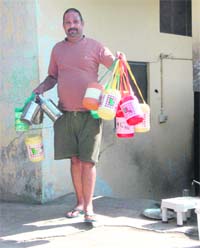 Manoj, a dabbawala, takes tiffins for delivery in Dehradun