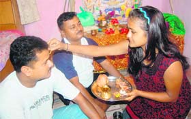 A sister applies tilak on the forehead of her brother on the festival of Bhai Dooj in Dehradun