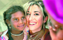 A village girl poses with a foreign tourist at Pushkar on Monday.