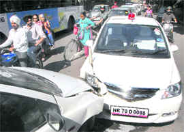 The two cars which collided head on in front of the petrol station in Sector 10, Chandigarh, on Tuesday.