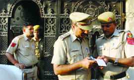 Delhi police personnel outside the Jamia Nagar house where two eunuchs were found dead in New Delhi on Tuesday.