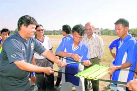 Charlton Chapman gives a demonstration of football equipment to students in Dehradun