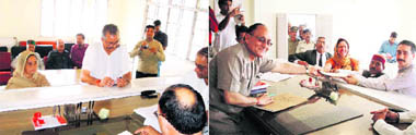 Congress candidate Sujan Singh (left) and BJP candidate Baldev Choudhary filing nomination papers for the Jawali by-elections on Tuesday.