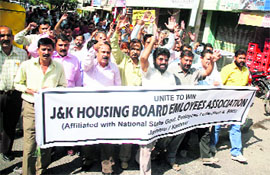 Members of the Housing Board Employees Association protest in front of the office of the boards managing director in Jammu on Tuesday.