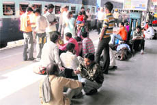 Migrant labourers wait for train back home to take part in Chhat Puja celebrations, at Ludhiana railway station.