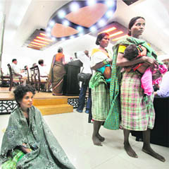 Tribal women from Dantewada in Chhattisgarh at a meeting organised by Citizen Initiative for Peace while a participant (in the backdrop) addresses the event, in New Delhi.